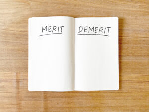 机に置かれたmerit demeritと書かれたノート